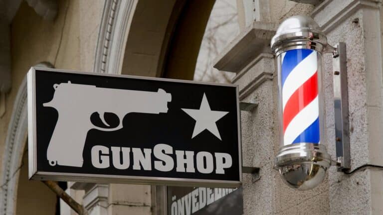 Gunshop sign beside barber pole firearms