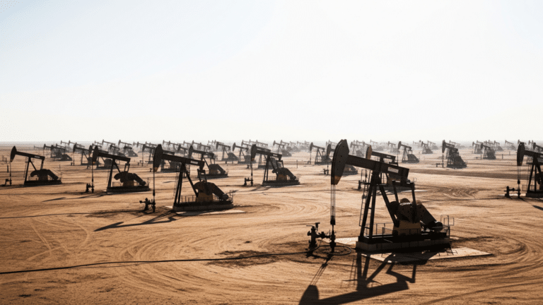 Active pump jacks in the Permian Basin crude oil field under midday sun