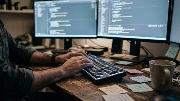 Developer hands at a keyboard with a terminal showing Git 2.55 commands