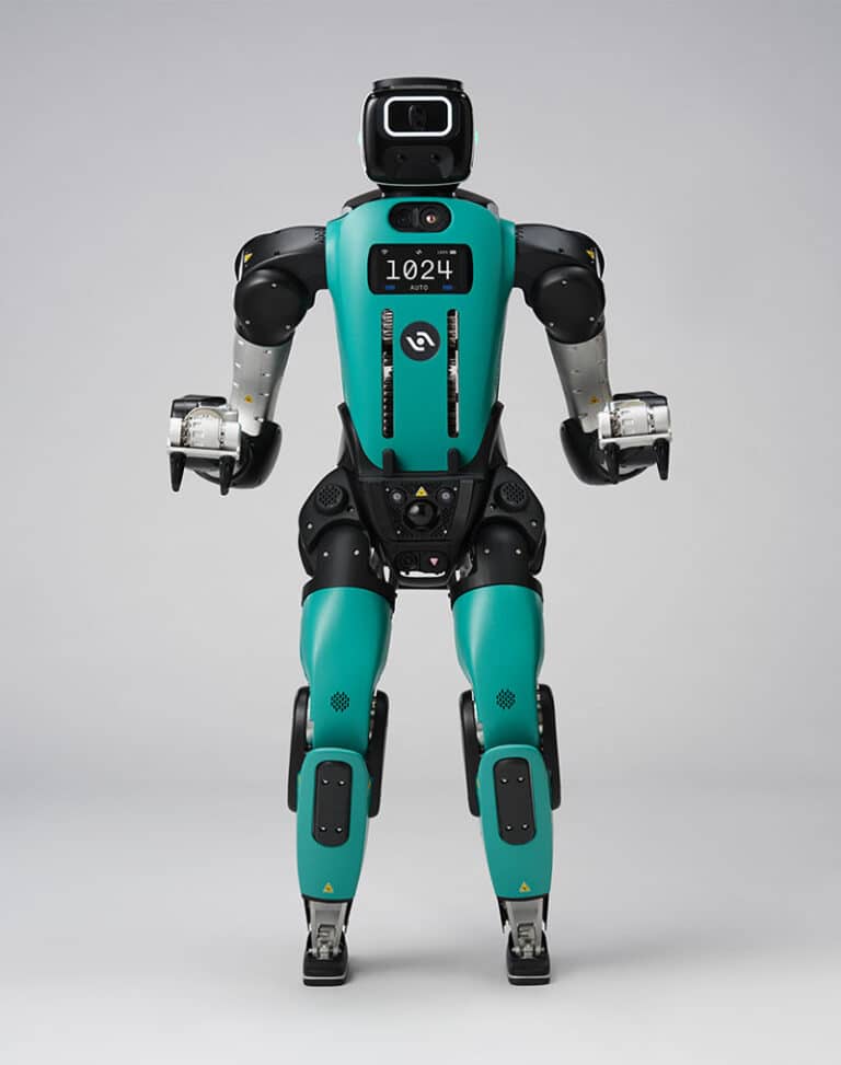 Digit 5 humanoid robot on a warehouse floor beside workers