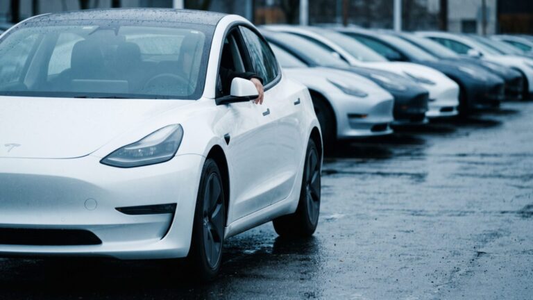 Low-angle shot of a white compact electric vehicle SUV showing electric vehicle sales momentum