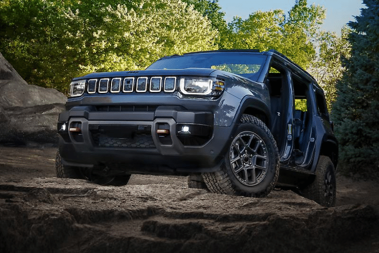 2026 Jeep Recon electric off-roader on a rocky desert trail with doors removed, jeep puts