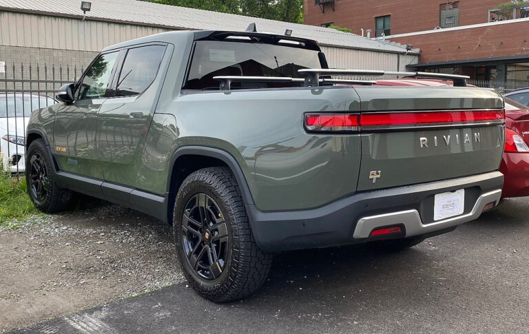 Rear view of a Rivian electric pickup truck showing camera housing detail, rivian s
