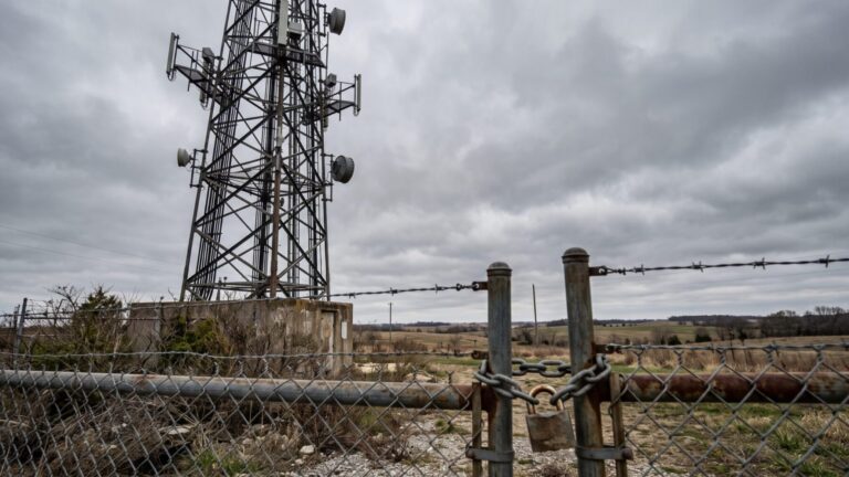 Padlocked cell tower compound gate illustrating the American Tower cell tower breach, shinyhunters publishes