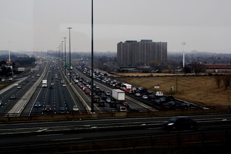 Dense urban highway traffic jam illustrating traffic congestion cost per driver, traffic cost