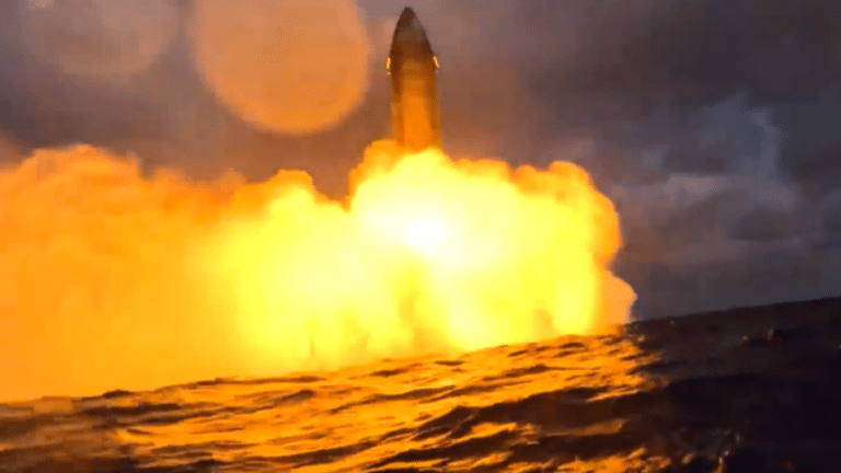 Tall rocket on a coastal launch pad at dawn before a Starlink V3 deployment mission