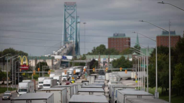 Car carrier trucks wait at border amid Canada auto tariff dispute