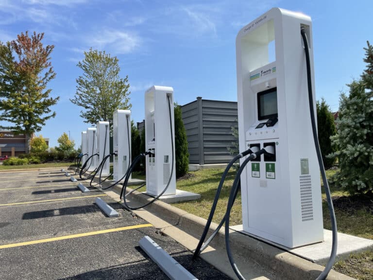 Electric vehicle plugged into a public charging network station