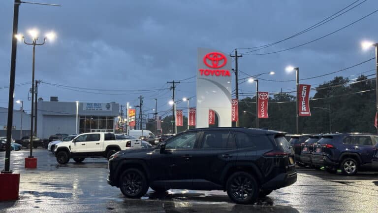 Electric car at a dealership lot showing new sales share reality