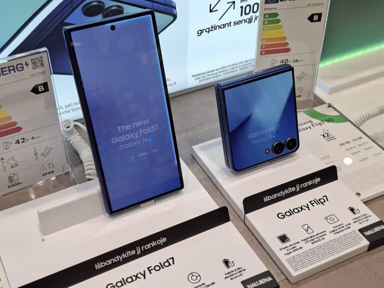Hand folding a foldable smartphone screen at a store counter