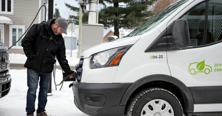 Mechanic inspects a certified used commercial work van