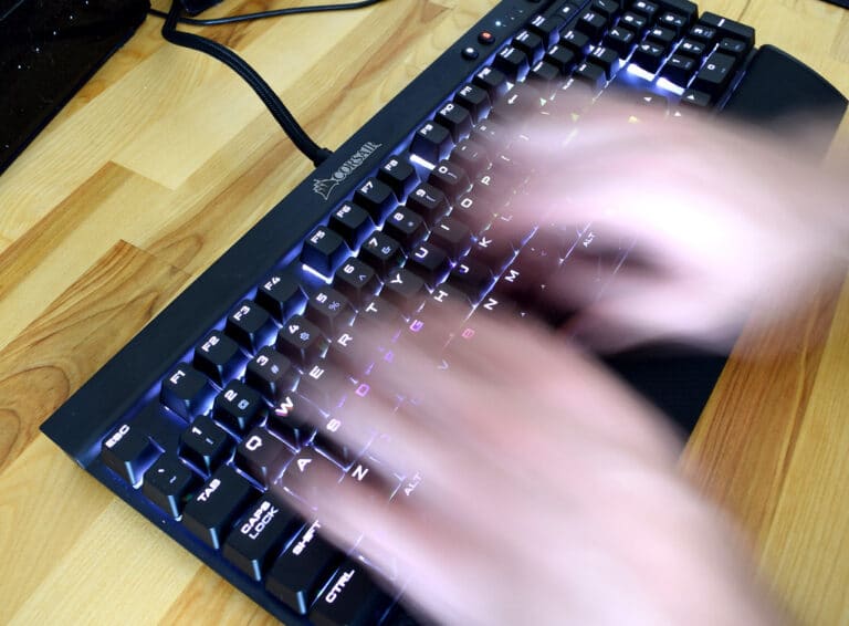 Developer hands typing with terminal showing assisted permissions prompt, github copilot