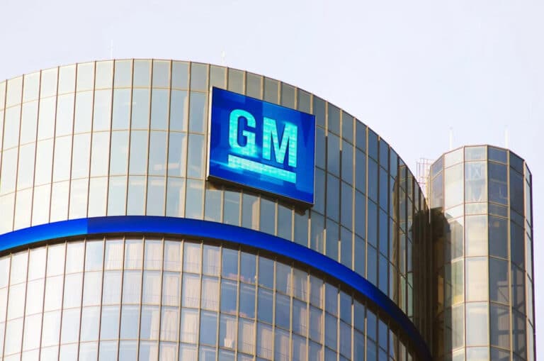 Rows of trucks outside plant as GM earnings report, gm heads