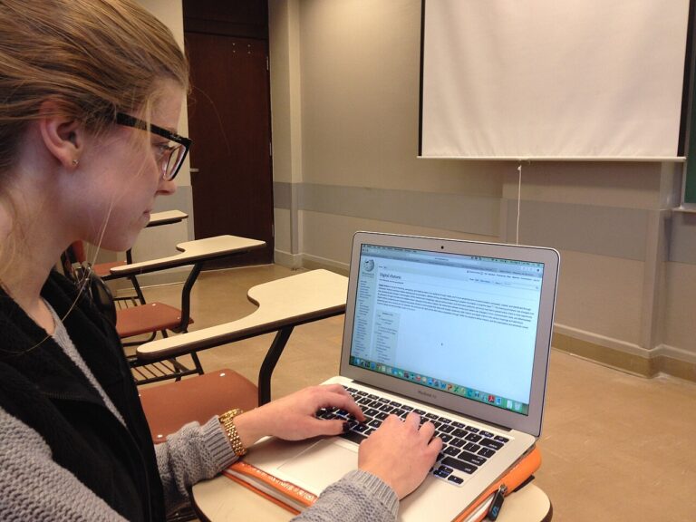 Student hands typing on laptop using Gemini student hub tools