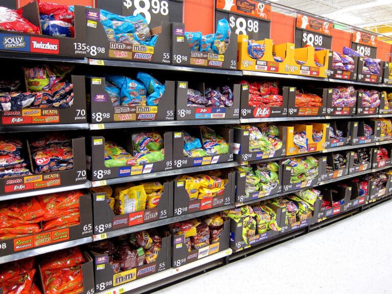 Shopper reaching for candy on a store shelf, Halloween spending record