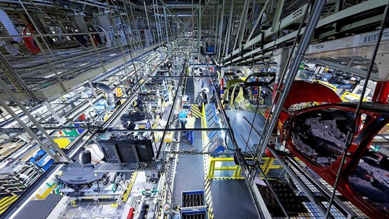 Welding robots inside a flexible body shop building multiple vehicle models, illinois auto