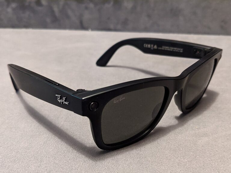 Ray-Ban Audio glasses and charging case on a desk, meta launches