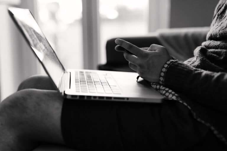 Hands typing near a laptop showing Office in Copilot interface, microsoft puts