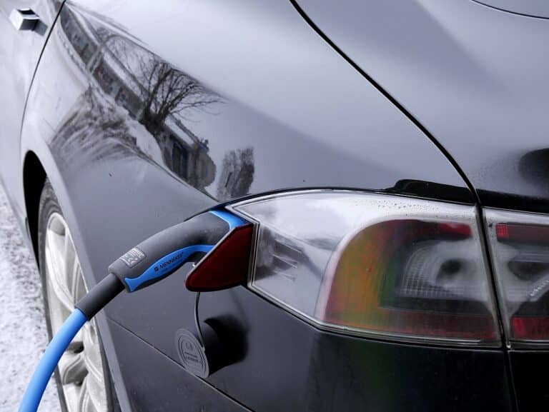EV charging cable plugged into car under a home charging credit change, new jersey