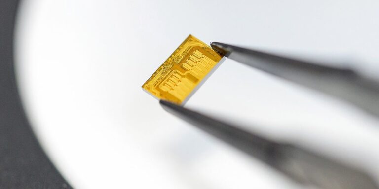Close-up of a chip with optical interposer circuitry in a cleanroom