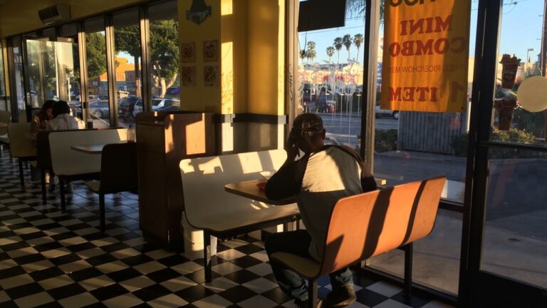 A single table for one set for solo dining in a restaurant, server clears
