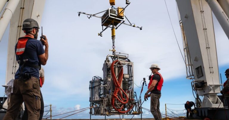 Subsea geothermal equipment lowered from ship into Pacific Ocean