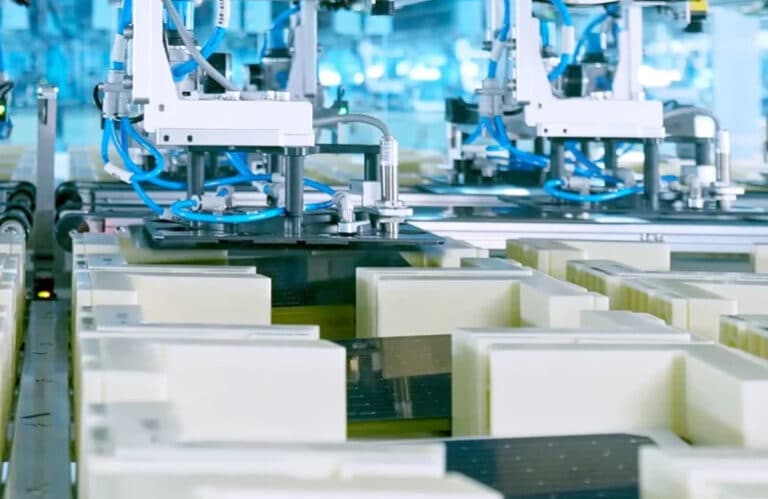 Worker guides solar panel on assembly line at Texas solar factory, toyo expands