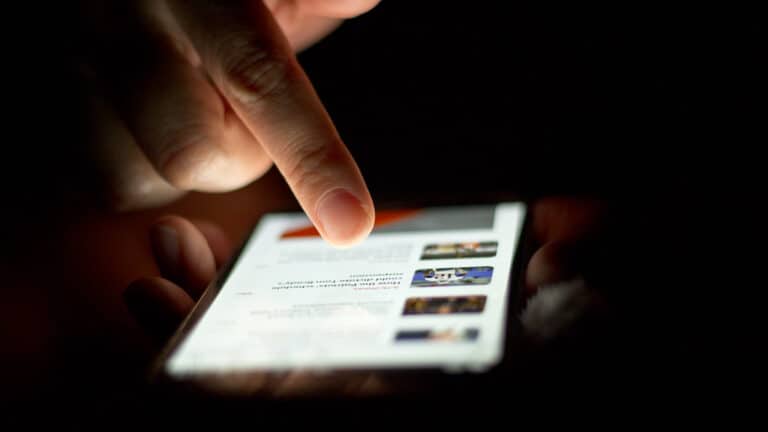 Hand scrolling a phone feed showing Your Algorithm controls